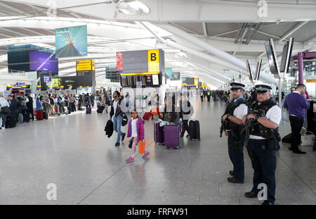 London, UK. 22nd Mar, 2016. British police officers patrol the airport at Heathrow Airport Terminal 5 in London, Britain on March 22, 2016, after the Brussels explosions on Tuesday morning. Credit:  Han Yan/Xinhua/Alamy Live News Stock Photo