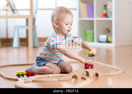 child boy playing with toys indoors at home Stock Photo