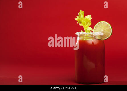 Bloody Mary cocktail on a red background Stock Photo