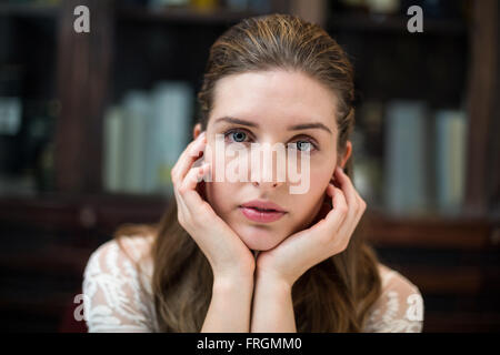 Portrait of sad woman with hand on chin Stock Photo