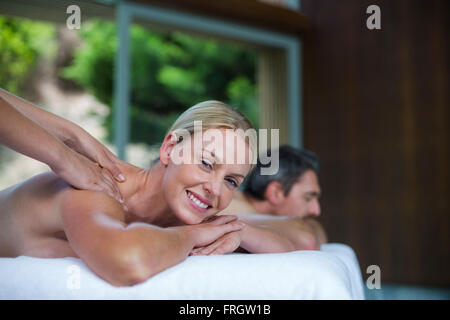 Woman receiving back massage from masseur Stock Photo