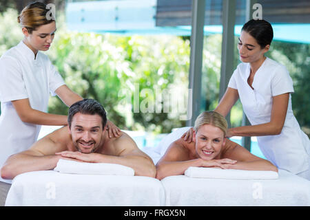 Young couple receiving a back massage from masseur Stock Photo