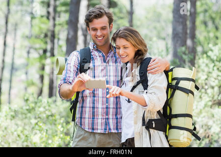 Happy couple looking at smart phone Stock Photo