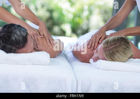 Young couple receiving a back massage from masseur Stock Photo