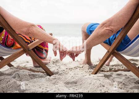 Senior couple relaxing on deckchairs Stock Photo