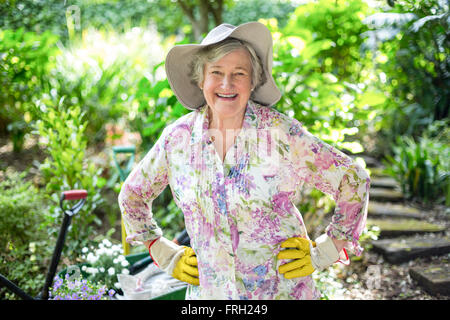 Happy senior woman standing in garden Stock Photo