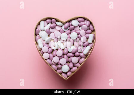 Generic pills and capsules in heart shape. Stock Photo