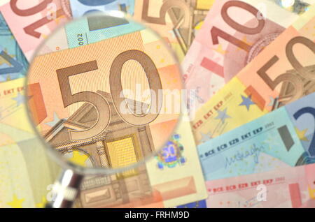 euro banknotes under magnifying glass Stock Photo