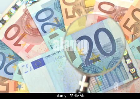 euro banknotes under magnifying glass Stock Photo