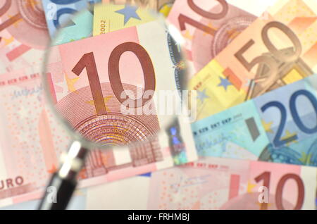 euro banknotes under magnifying glass Stock Photo