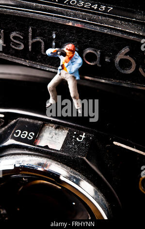 photographer figurine on a photo camera, photography concept Stock Photo
