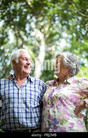 Happy senior couple laughing while looking at each other Stock Photo