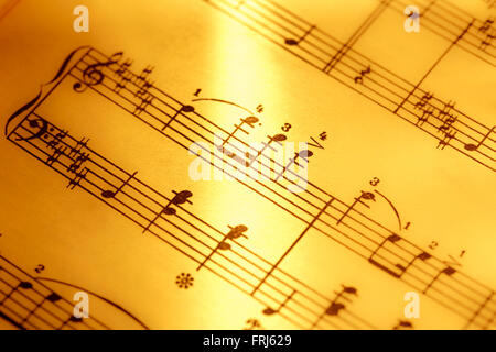 Music notes in yellow toning in closeup Stock Photo