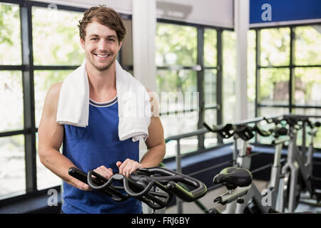 Man standing in spinning class Stock Photo