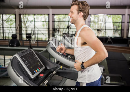 Man running on thread mill Stock Photo