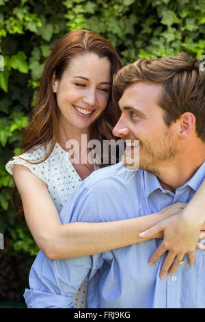 Young couple hugging at front yard Stock Photo