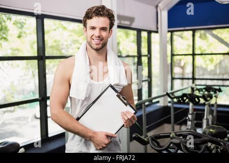 Gym instructor holding clipboard Stock Photo