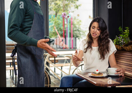 Disagreement between a waiter and a customer Stock Photo