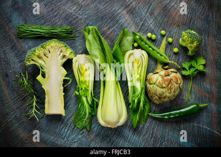Collection of fresh green vegetables on black stone Stock Photo