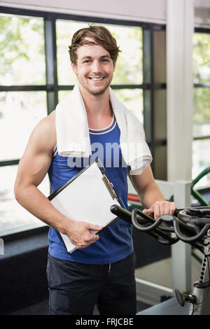 Gym instructor holding clipboard Stock Photo