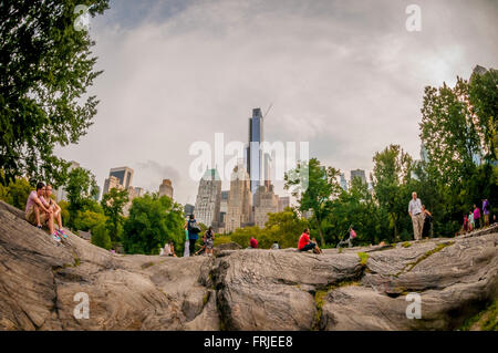 Umpire Rock, Central Park, New York City, USA. Essex House Central Park South in background. Stock Photo