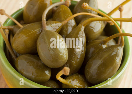 Bowl with pickled caperberries close up Stock Photo