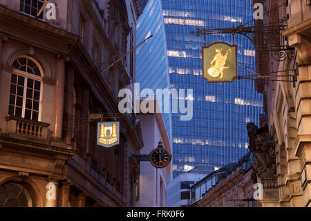 Old buildings and traditional commercial signs alongside modern architecture in historic Lombard Street. The City of London, England, United Kingdom. Stock Photo