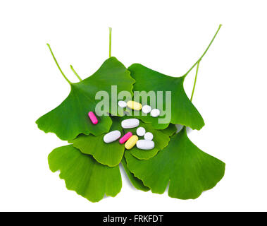 Ginkgo leaves and pills isolated on white Stock Photo