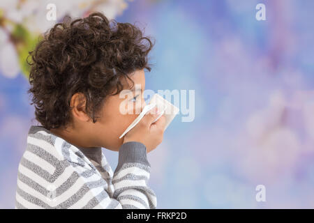 child with curly hair suffering from the flu. Stock Photo