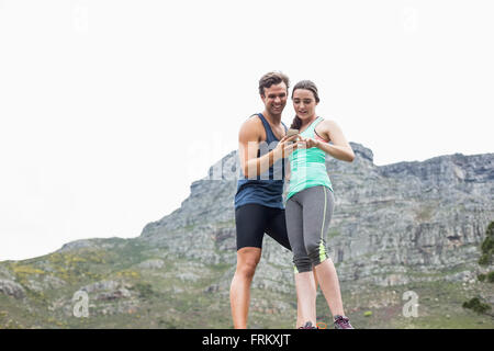 Low angle view of couple using cellphone Stock Photo