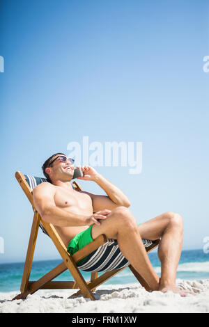 Man relaxing and using smartphone Stock Photo