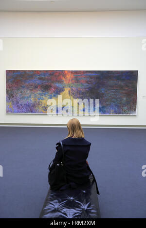 Woman in front of Claude Monet's Les Nymphéas water lily painting in the Kunsthaus Zurich museu, Zhrich, Switzerland Stock Photo