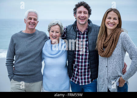 Cheerful family standing on shore at beach Stock Photo
