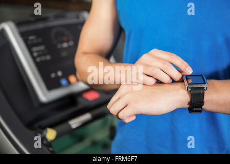 Man using smart watch on treadmill Stock Photo