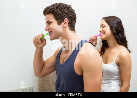 Couple brushing their teeth in bathroom Stock Photo