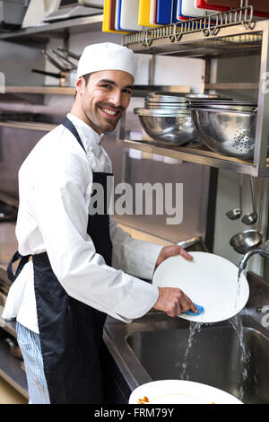 Handsome employee doing dishes Stock Photo