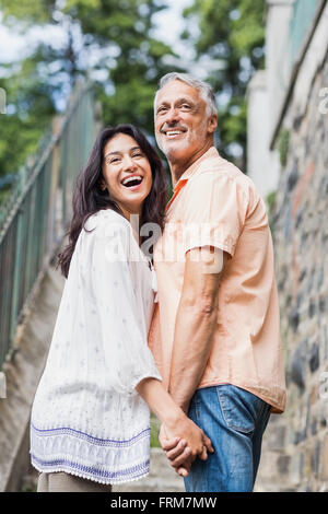 Cheerful couple looking over shoulder Stock Photo