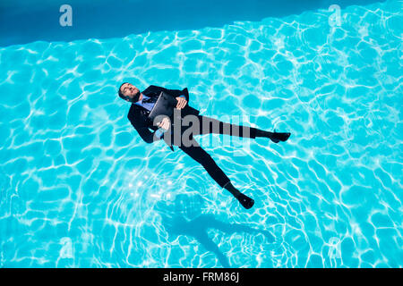 Dressed businessman in swimming pool Stock Photo