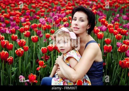 Mother with her daughter on thee flowers field Stock Photo