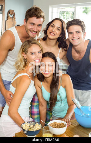 Happy young friends making breakfast at home Stock Photo
