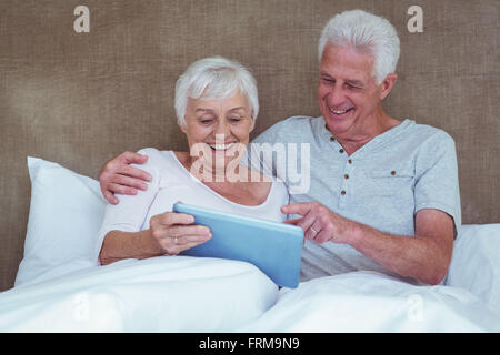 Cheerful senior couple using digital tablet Stock Photo