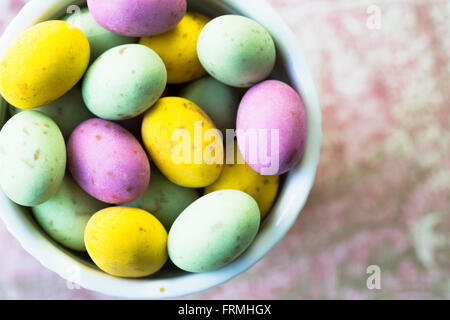 Milk chocolate easter eggs in cup seen from directly above. Stock Photo