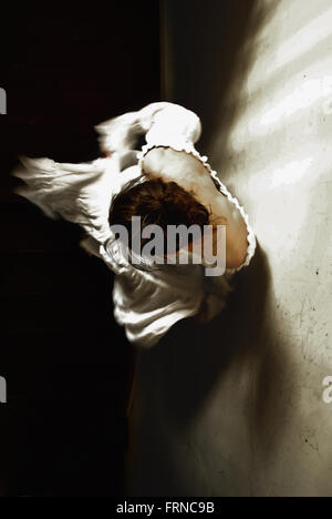 high angle view of the woman coming don the stairs in an old house Stock Photo