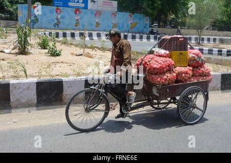 Rickshaw carrying potatoes, New Delhi, India Stock Photo