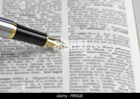 The word 'love' in a dictionary. With a fountain pen. Shallow d o f Stock Photo