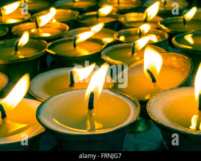 Butter lamps in a buddhist monastery, split tone effect. Stock Photo