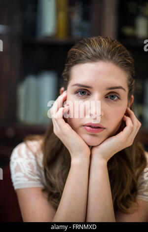 Portrait of serious woman with hand on chin Stock Photo