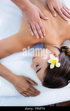 Masseuse giving massage to relax woman Stock Photo