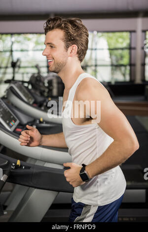 Man running on thread mill Stock Photo