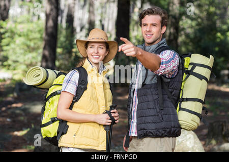 Young man pointing away during hiking with partner Stock Photo